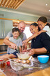 © Caia Image - Happy family baking together in kitchen at home