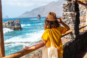 Wall Mural - A tourist looking at the pools from the recreational area of La Maceta on the island of El Hierro, Canary Islands