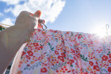 Hand Pegging Up Washing With Metal Peg Floral Girls Dress