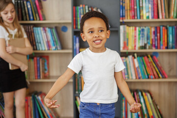 Wall Mural - Mixed race schoolboy having fun and running indoors at school. Back to school.