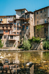 Wall Mural - The Pont-en-Royans village with its hanging houses and the blue waters of the Bourne river in the Vercors, mountains of the French Alps