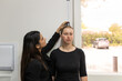 © Austockphoto - woman measuring the height of another woman using a height ruler on the wall of medical practice