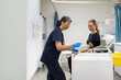 © Austockphoto - woman in the clinic getting a blood test by a female health worker