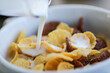 © RooM The Agency - Close-up of milk being poured into a bowl of chocolate and vanilla breakfast cereal
