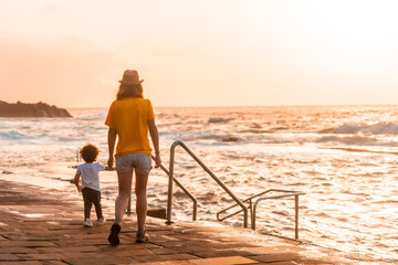 Wall Mural - Mother with her son at sunset in the La Maceta rock pool on the island of El Hierro en la Frontera, Canary Islands