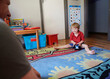 © Austockphoto - Boy Playing with Toy on Floor while Dad Watches