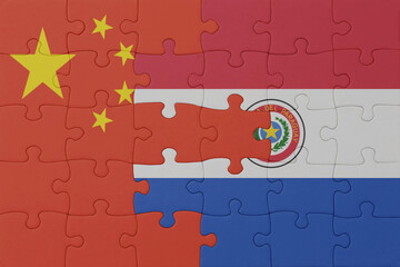puzzle with the national flag of paraguay and china . macro.concept.