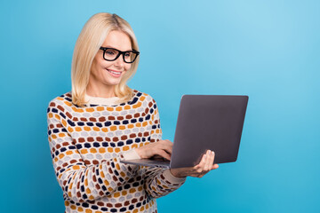 Sticker - Photo of confident positive girl wear sweater spectacles working modern gadget empty space isolated blue color background