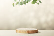 © Natalia Klenova - Wood slice podium with eucalyptus leaves on beige background for cosmetic product mockup