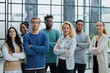 © Katsiaryna - Group of business people standing at the window of a modern office