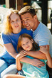© andrey - Happy family in the morning on the terrace.Mom, dad and daughter are on vacation