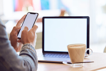 Poster - What a great work space. a man using his smartphone and laptop to work in a coffee shop while enjoying a cup of coffee.