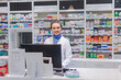 © Halfpoint - Portrait of young pharmacist selling medication in pharmacy.