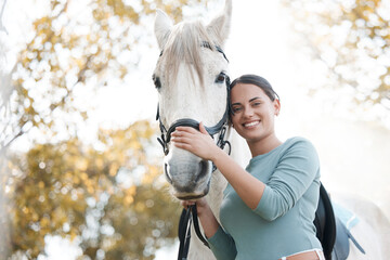 Poster - It is a noble and resilient force. an attractive young woman standing with her horse in a forest.