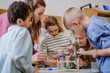 © Halfpoint - Young teacher doing chemistry experiment with pupils during science education.