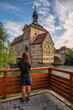 © Noppasinw - Bamberg Germany, city skyline at Altes Rathaus Old Town Hall and Linker Regnitzarm River with woman tourist