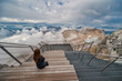 © Noppasinw - Alps mountain range view from Zugspitze Peak top of Germany with woman tourist, Garmisch Partenkirchen Germany