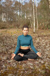 © Elena - Female doing yoga exercise in a park outdoors - Healthy lifestyle and sport concept