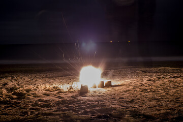 Wall Mural - Exploding firecracker on the sand