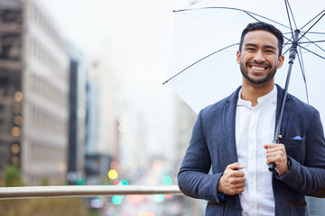 Sticker - Make sure youre covered. Cropped portrait of a handsome young businessman standing outside with an umbrella in the city.