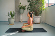 © ADDICTIVE STOCK - Asian woman in lotus pose on mat in studio