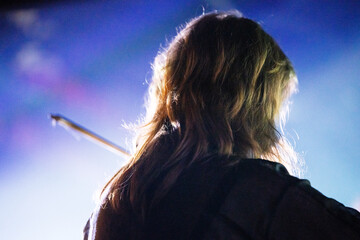 Canvas Print - Band playing music and a gig in a venue, close up of a rock band playing guitars and instruments.