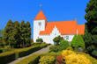 Traditional old Danish white church with red roof architecture