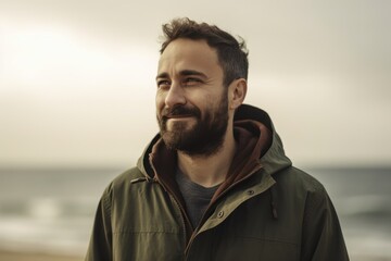 Medium shot portrait photography of a satisfied man in his 30s wearing a warm parka against a summer landscape or beach background. Generative AI