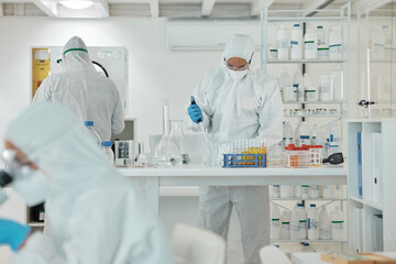 Wall Mural - conducting experiments under defined conditions. a scientist wearing a radiation suit while working 