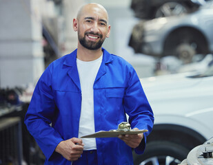 Sticker - Lets assess your vehicle. Cropped portrait of a handsome young male mechanic working on the engine of a car during a service.