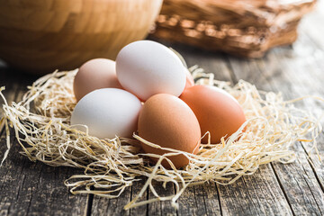 Poster - Whole chicken eggs on wooden table.