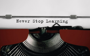 Wall Mural - text never stop learning typed on retro typewriter