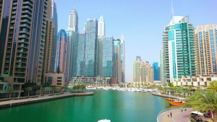 Poster - The boats floating along Dubai Marina, surrounded with forest of futuristic skyscrapers, Dubai, UAE
