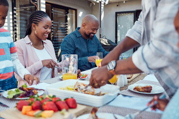 Wall Mural - Lunch is served. a happy family having lunch together outside in the garden.