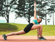 © Courtney/peopleimages.com - Your goals are within reach. Full length shot of an attractive young sportswoman stretching on a running track.