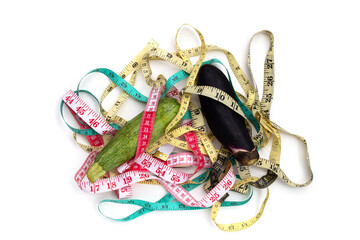 Zucchini and eggplant with measuring tape on white background