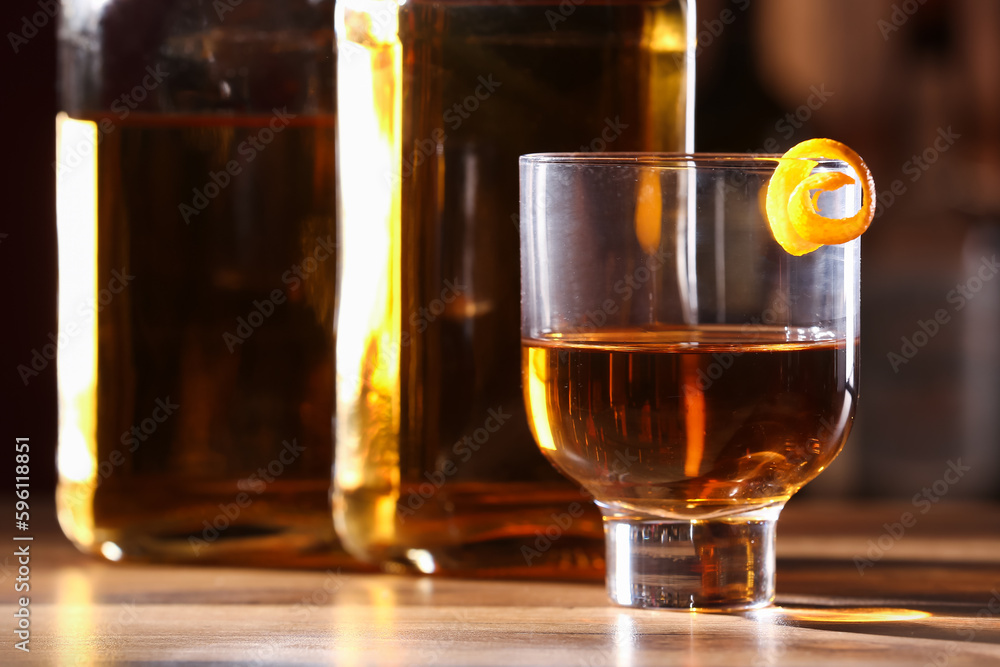 Glass of cold rum on table in bar