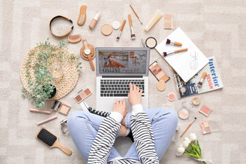 Poster - Woman with laptop, makeup products and accessories shopping online on beige carpet