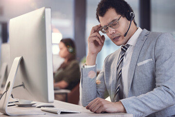 Poster - Im feeling a bit stressed. a young male call center agent suffering from a headache at work.