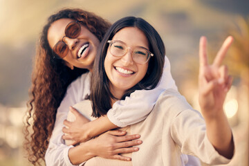 Wall Mural - Were all about positive vibes. a woman showing the peace sign while outside with her friend.