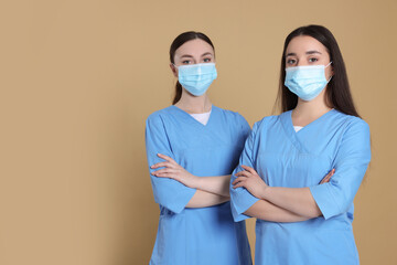 Sticker - Nurses wearing protective masks on light brown background, space for text