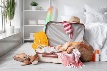 Canvas Print - Open suitcase with beach accessories in bedroom