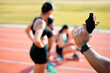 © Courtney/peopleimages.com - Trying to get them ready. Rearview shot of an unrecognizable man holding a starting gun while a group of sportswomen take up their positions on track.