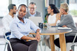 © D Lahoud/peopleimages.com - Winning is all we know. a young businesswoman sitting in an office with her colleagues in the background.