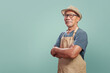 Portrait of Asian Senior man wearing brown apron smiling with arms crossed over isolated color background, Small business owner, Entrepreneur