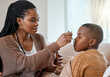 © K Davis/peopleimages.com - This will make you feel better. a young mother giving her sick son cough syrup at home.