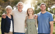 © S Fanti/peopleimages.com - Portrait of a loving caucasian family with adult children standing together in nature on a sunny day. Happy senior couple posing outdoors with their daughter and son in law