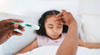 © Wesley JvR/peopleimages.com - Parent, hands and thermometer with sick kid checking fever or temperature for flu or cold on bed at home. Hand of adult monitoring child for illness, healthcare or virus in love, care or support