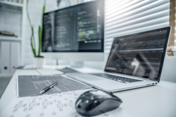 Wall Mural - programmer writing program code with two monitors and working on a new software or hacker programmin