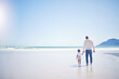 © Azeemud-Deen Jacobs/peopleimages.com - Father, boy and beach with mockup space, holding hands and blue sky with bonding with vacation in summer. Papa, male kid and solidarity with trust, holiday and ocean mock up with waves in sunshine